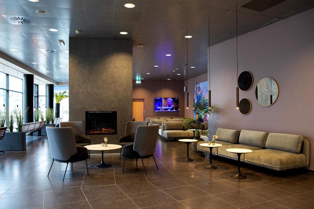 A compact hotel room with a fixed berth, a desk shelf and a moulded bathroom door.