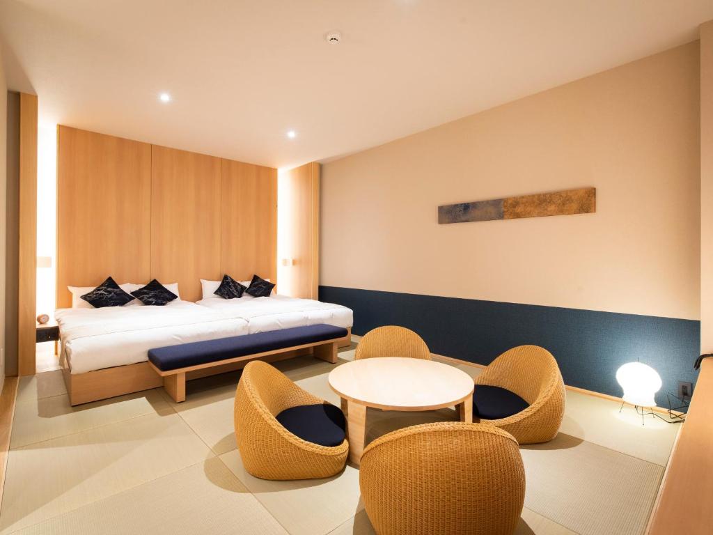 A corridor of partitioned cabins open at the top, under even ceiling light.